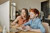 Child and adult on computer