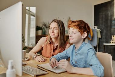 Child and adult on computer